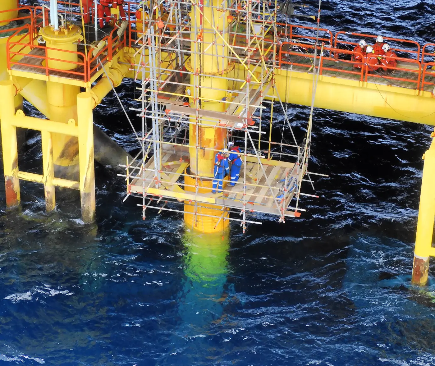 Composite sleeves installed on platform risers in the splash zone