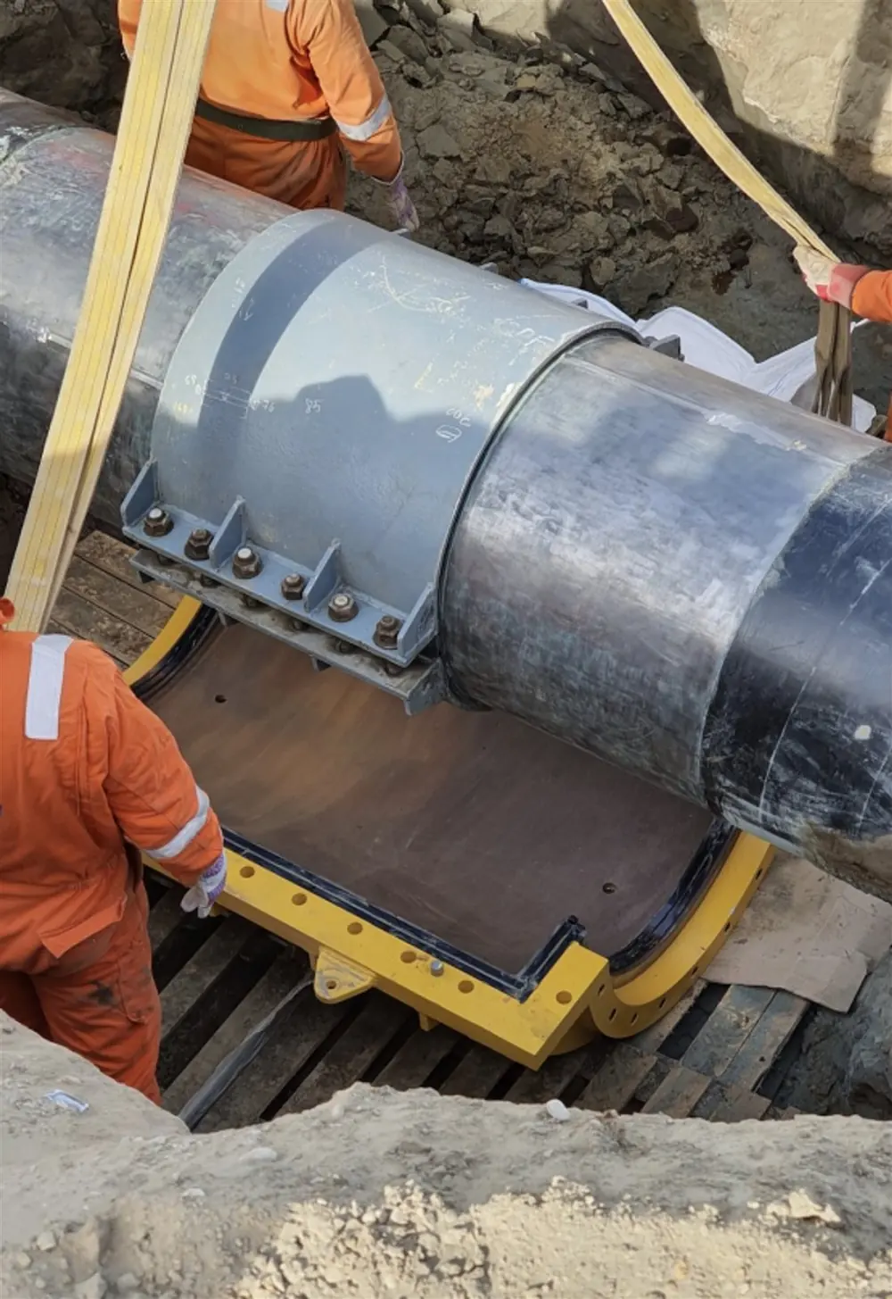 Lower shell positioned under a live buried line.